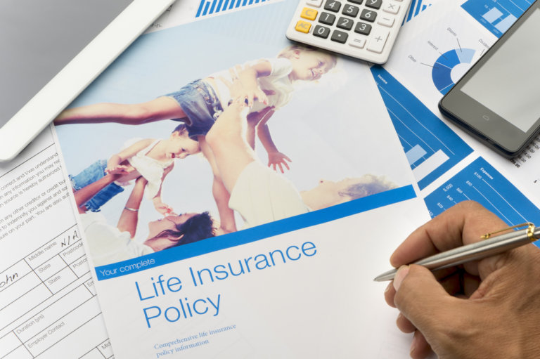 man signing life insurance policy