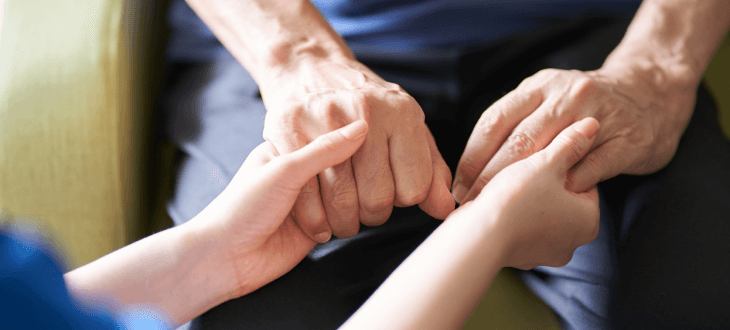 Senior holding hands with their caregiver